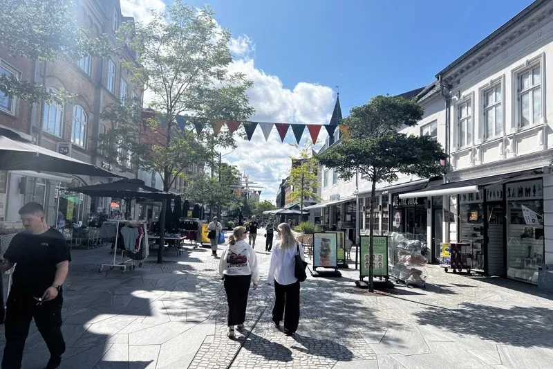 Herning city centre pedestrian street with shops and summer decorations in Jutland, Denmark